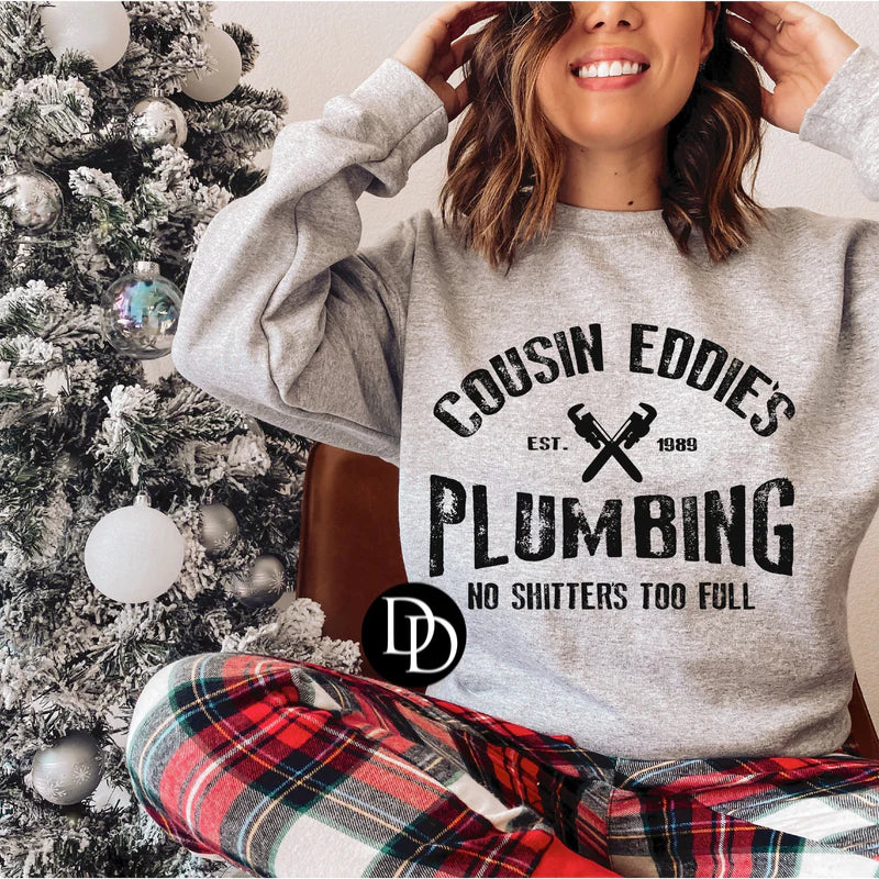 Front View. Cousin Eddie's Plumbing No Shutters Too Full Graphic-29eleven | Women’s Fashion Boutique in Menan, Idaho